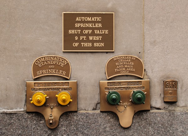 Two flush fire department connections with brass plates