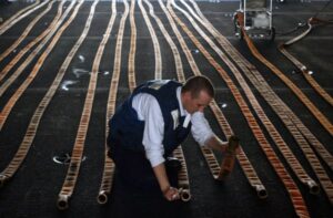 Carefully inspecting laid fire hose
