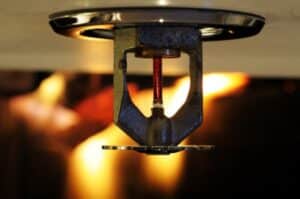 Flame behind a fire sprinkler